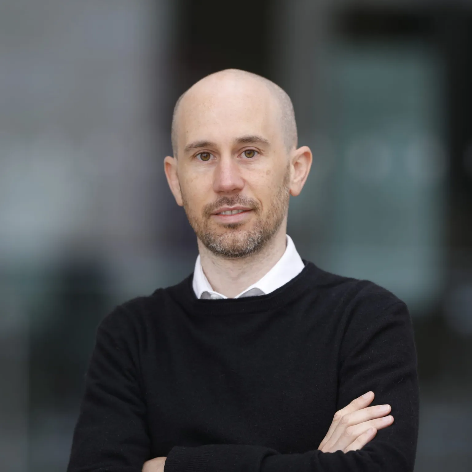 Black and white headshot of Rikki Dean